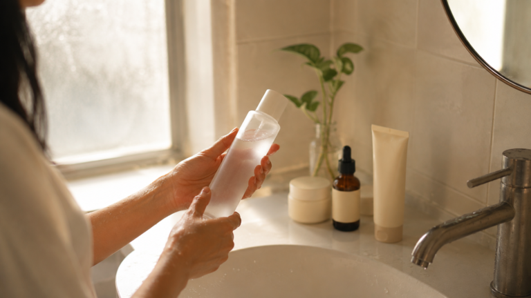 Woman applying toner in morning routine — fewer steps for Korean skincare in humid weather